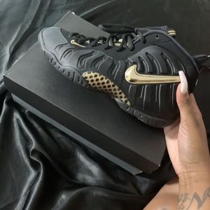 black and metallic gold foamposite pro